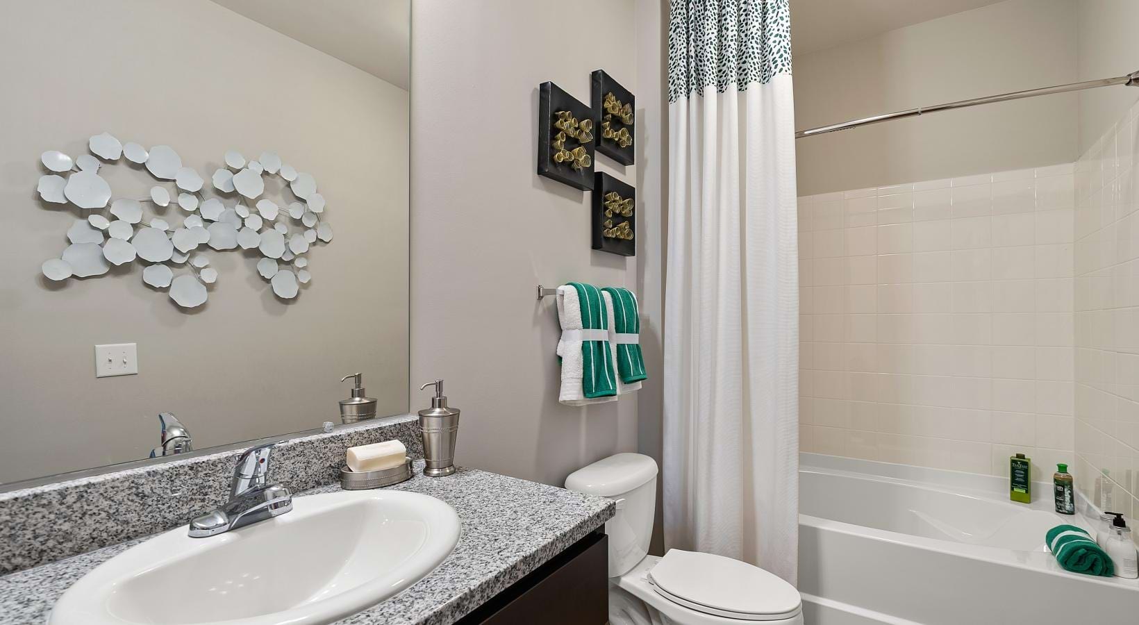 Spacious bathrooms with everything you need a bathroom with a sink toilet and bathtub