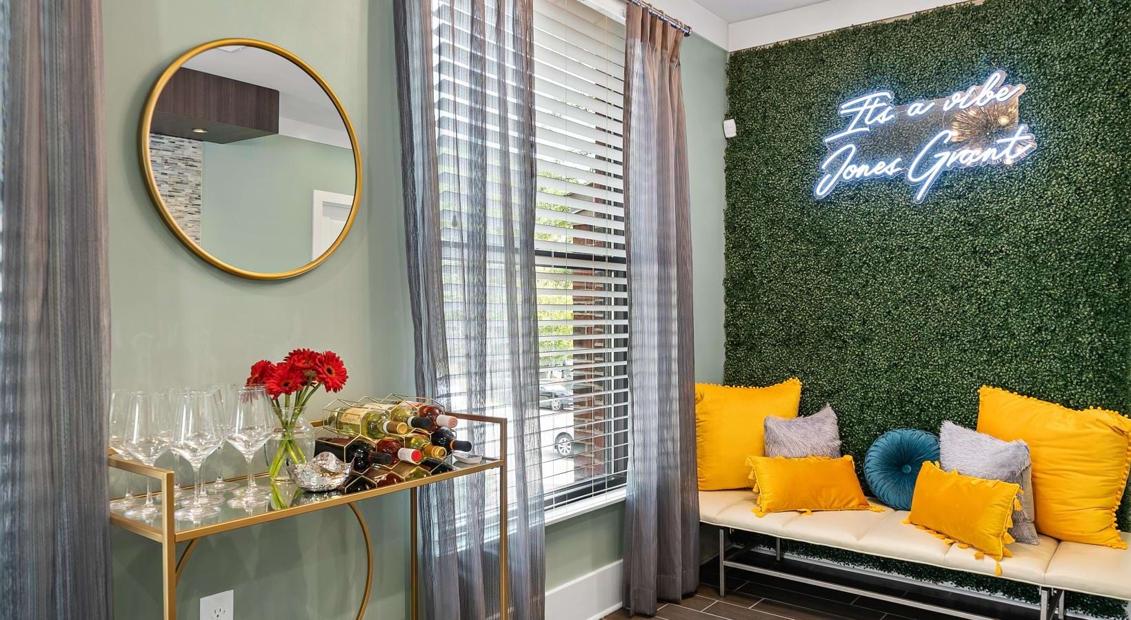 Settle into comfort at Jones Grant a room with a couch and a table with a mirror