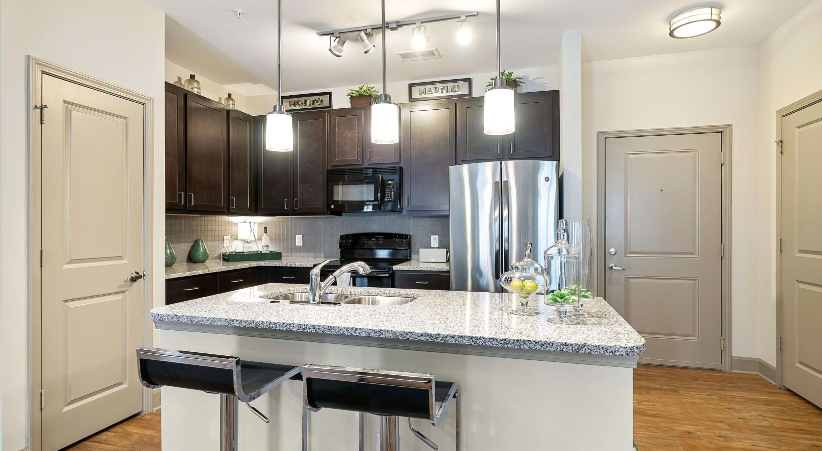 Spacious kitchens with thoughtful details a kitchen with black cabinets