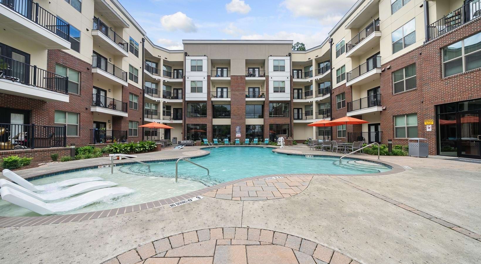 A perfect fit for the whole family a pool in a courtyard between buildings