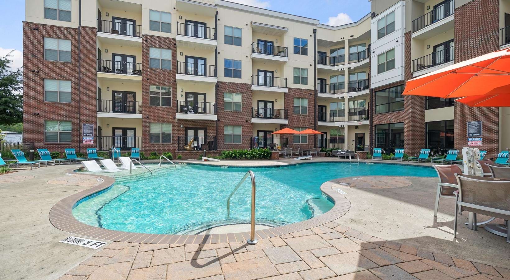 Resort-style swimming pool a swimming pool in front of a building