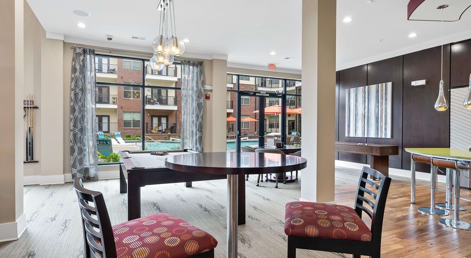 A perfect fit for the whole family a room with a table chairs and a chandelier