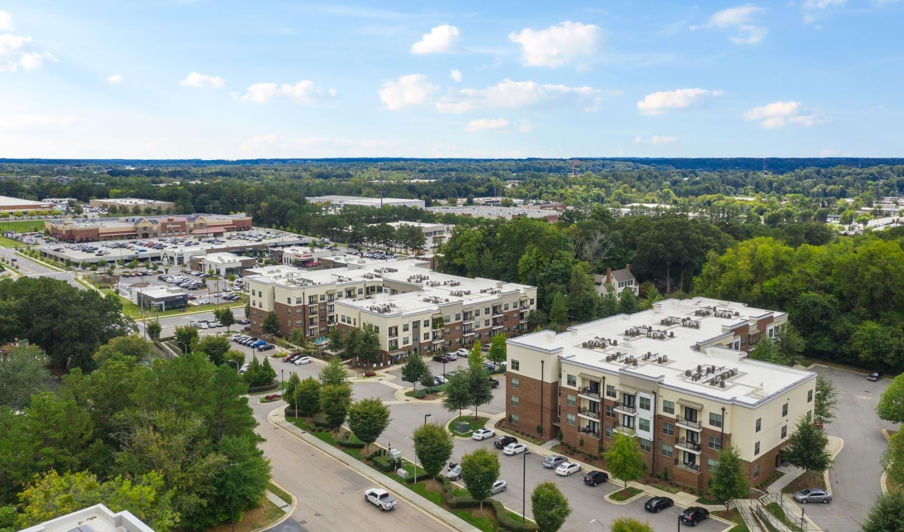 Find your perfect fit at Jones Grant Aerial view of Jones Grant Raleigh apartments for rent, adorned with lush walkable green spaces.