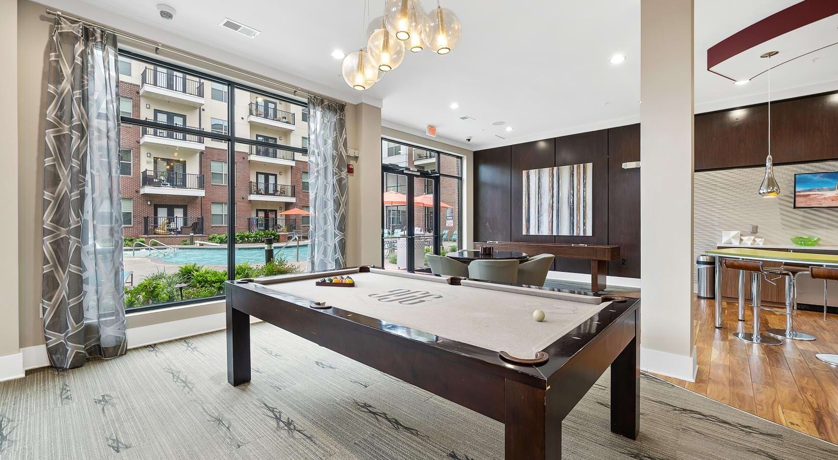 Take advantage of all Jones Grant has to offer a room with a pool table and chairs and a chandelier