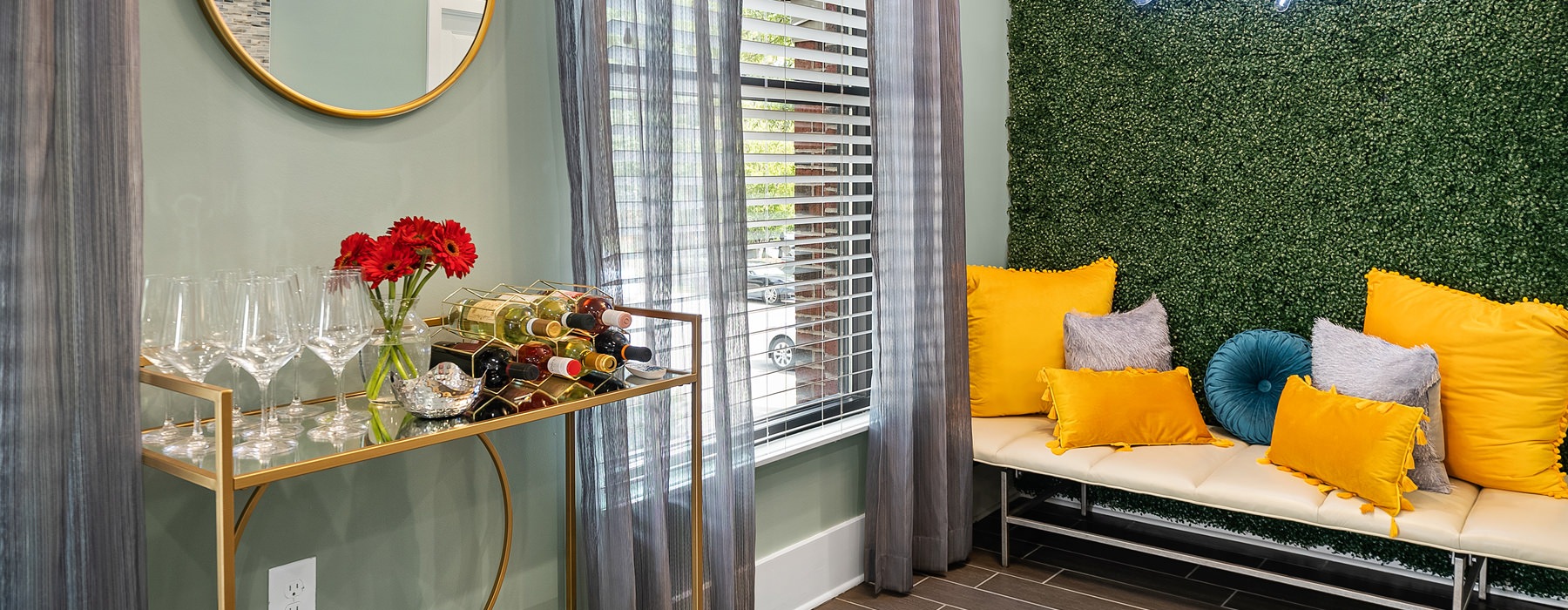 room with a desk and couch with a green wall